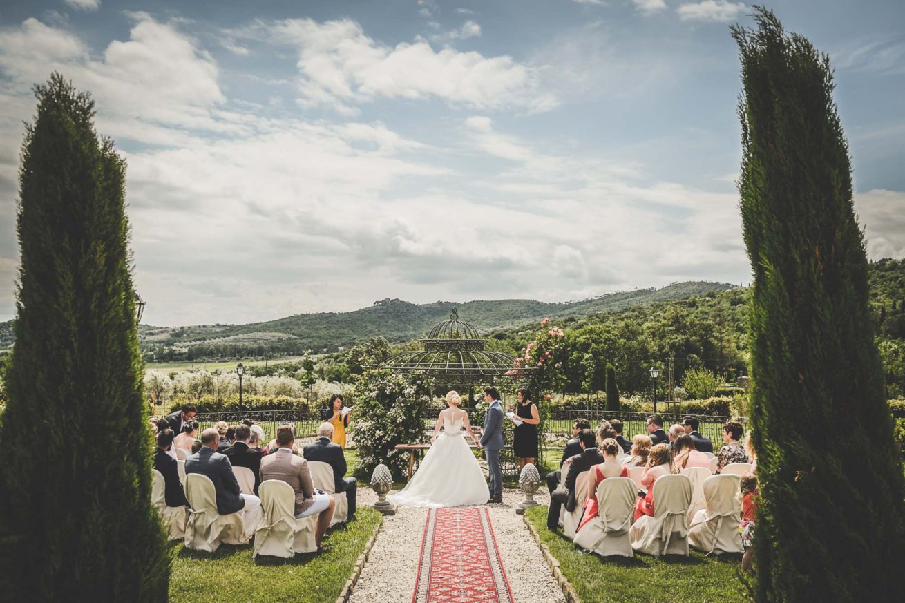 Garden villa wedding Italy. A moment of the legally binding ceremony celebrated in the lush garden.