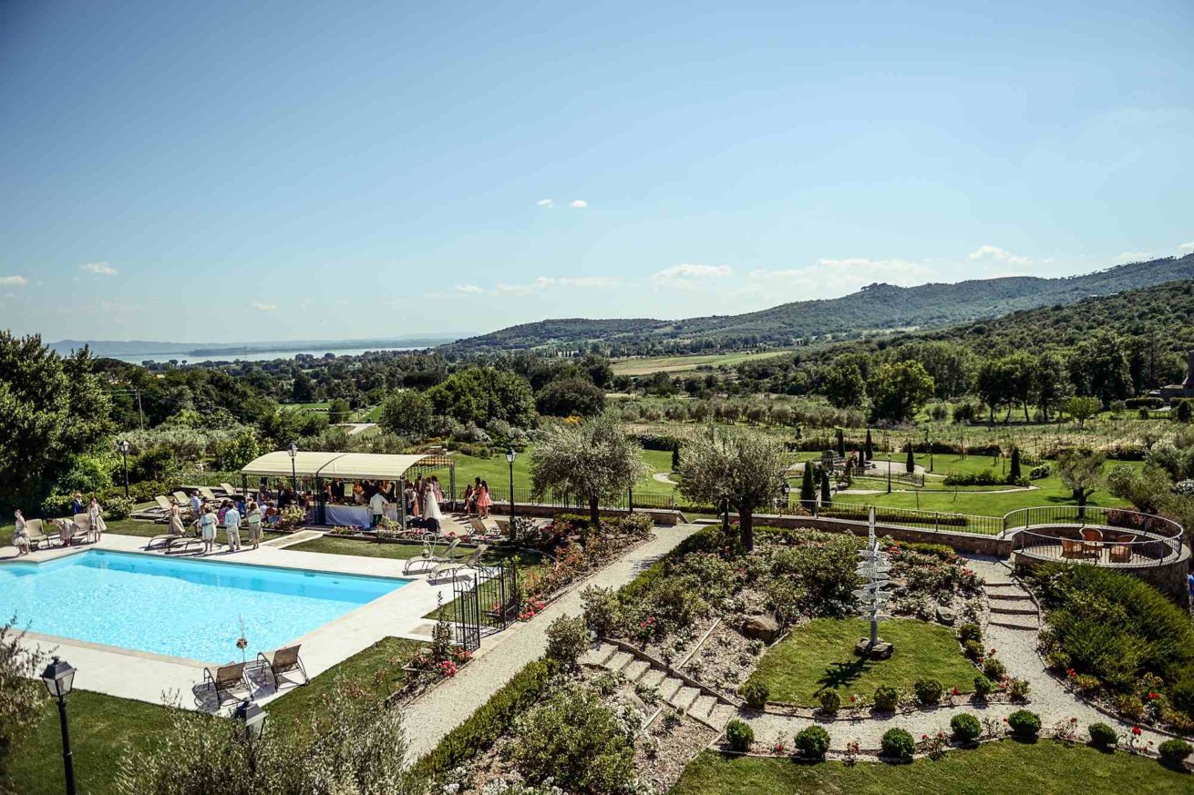 View of pool area and garden during aperitifs served at Exclusive weddings villa Italy Baroncino