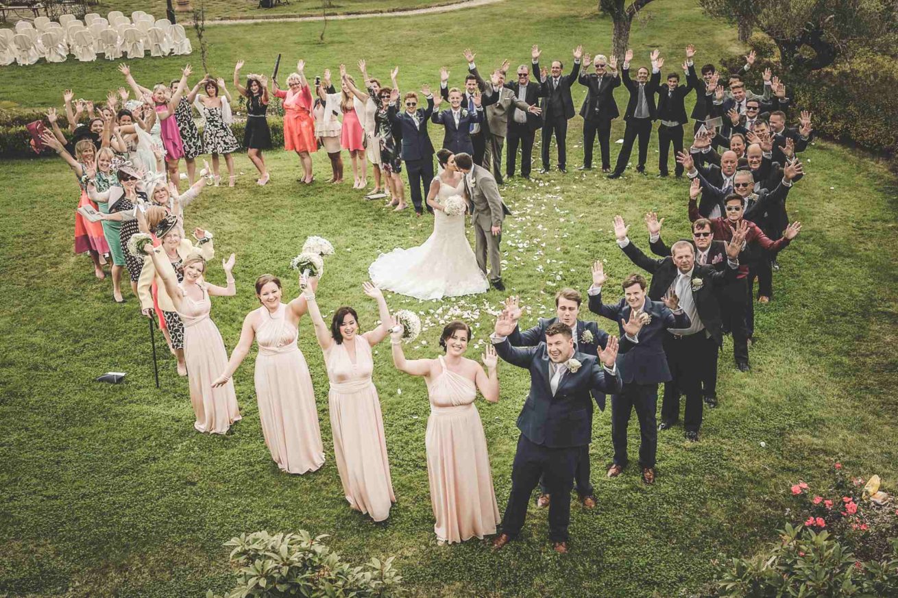 Italy villa sleeps 40 50 people group photo in a heart shape in the Weddings Italy garden at villa Baroncino